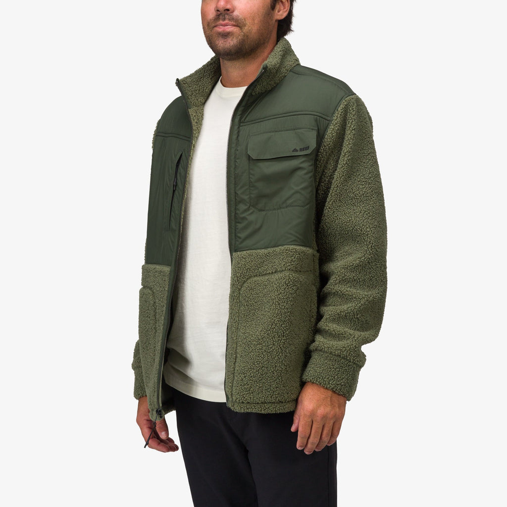 Man wearing olive green Cooke Sherpa Jacket facing forward, highlighting soft rebound cushioning and comfort features.