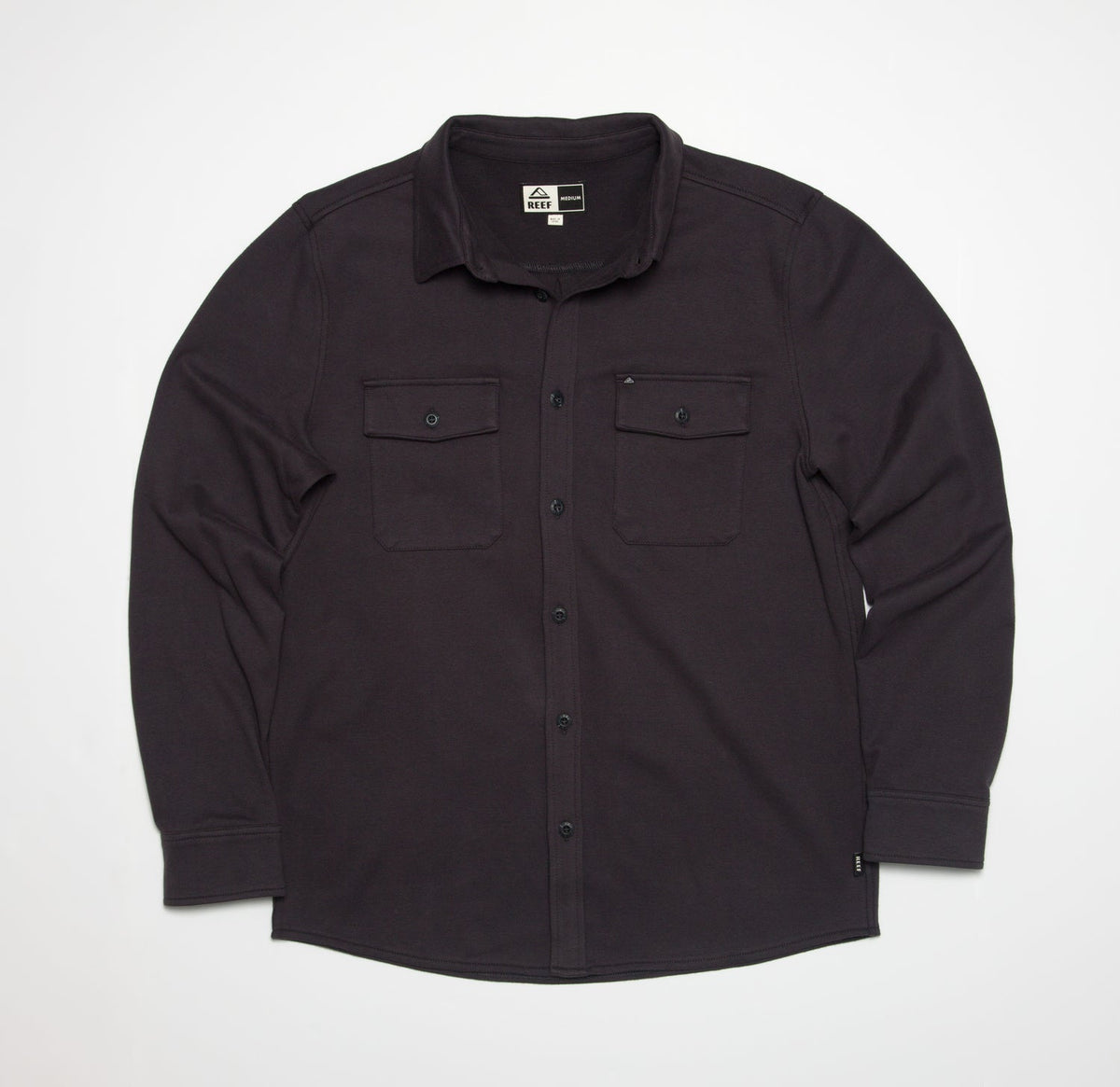 Front view of the Raymond Ls Shirt in dark fabric, featuring button closures and dual chest pockets.