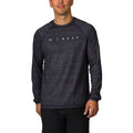 Man wearing a black wave-patterned Dune Performance Shirt facing front, highlighting comfort and surf-inspired design.