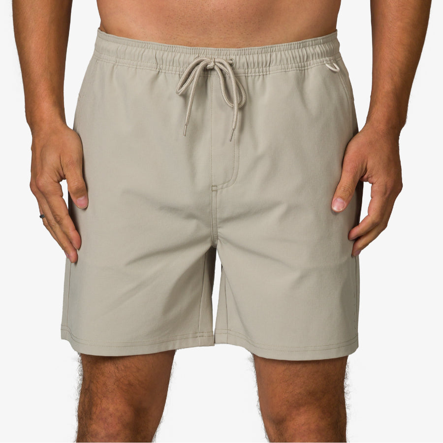 Front view of men's Rushmore Hybrid Short in beige, surf-inspired comfort apparel for beach and active lifestyles.