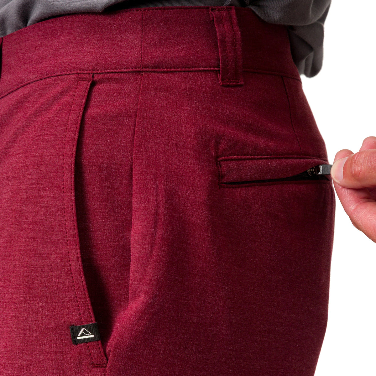 Close-up of the right side of men's Destro Hybrid Short in deep red fabric, showing zipper pocket detail.