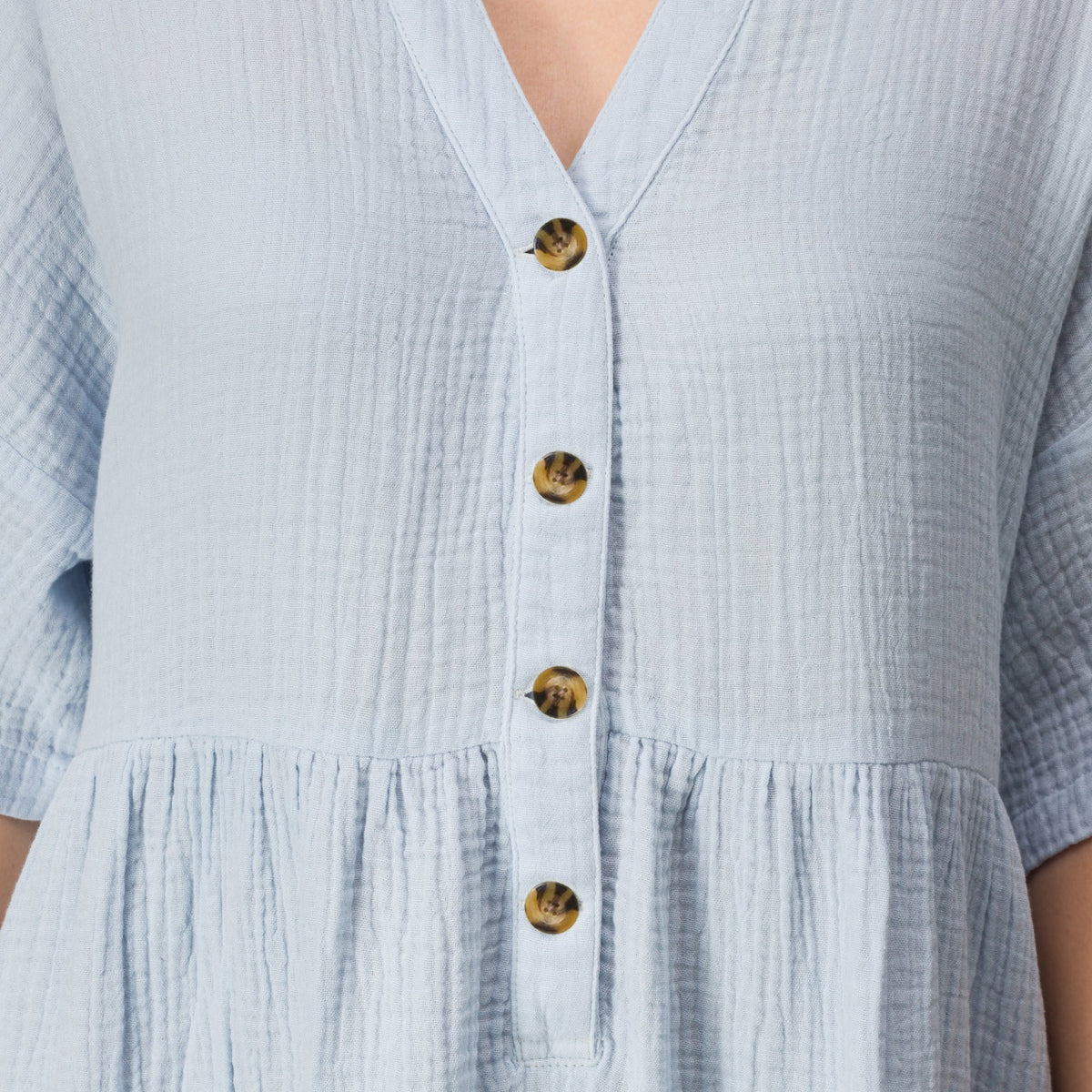 Close-up of the upper front buttons and textured fabric of the light blue Lainey Shirt Dress for women.