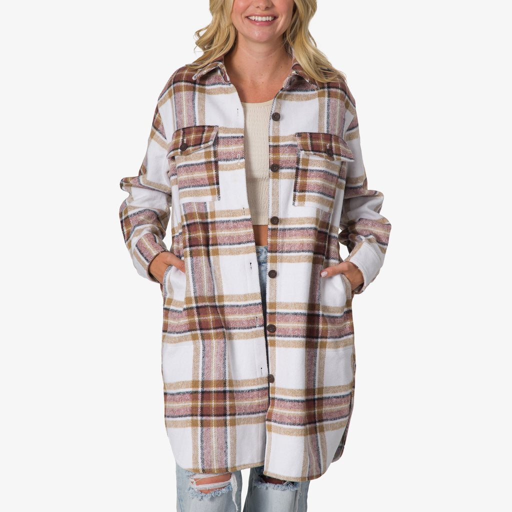 Woman wearing a front-facing Victoria Shacket in white and brown plaid, hands in side pockets, styled with ripped jeans and a light top.