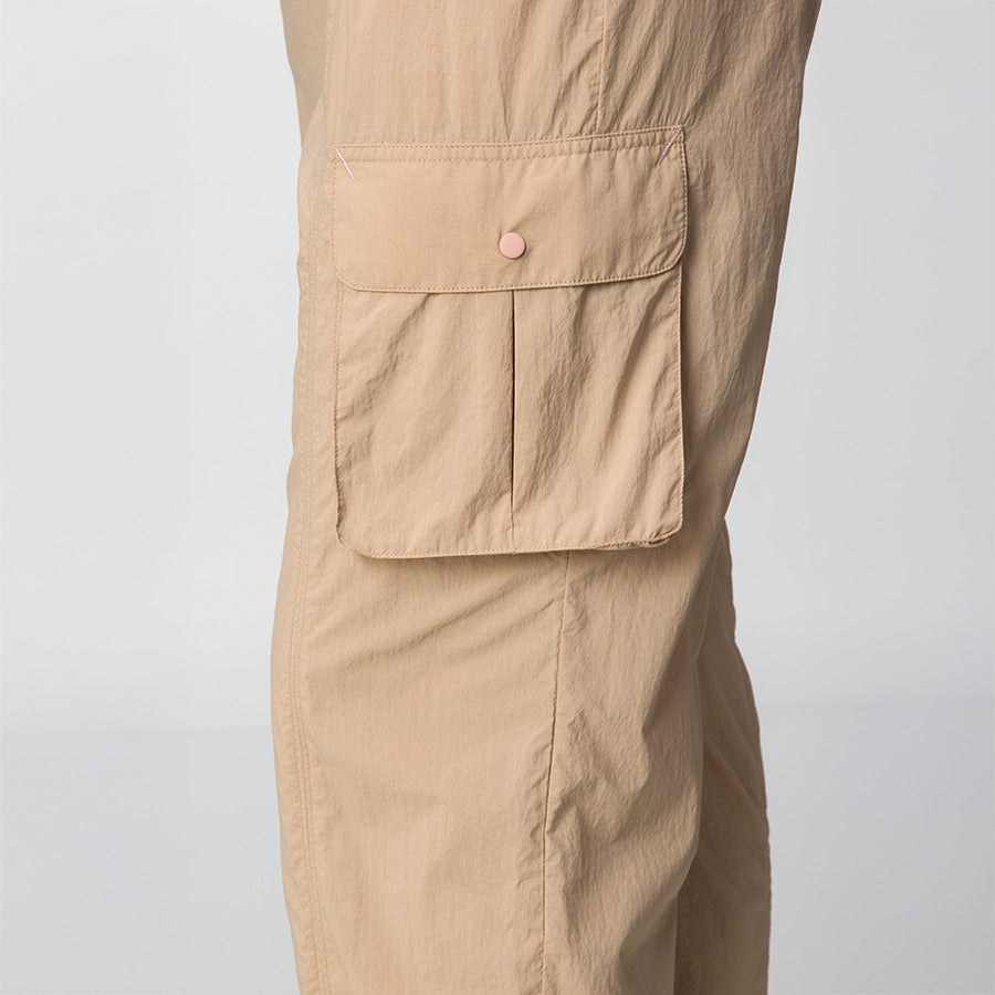 Close-up of side pocket detail on women's Cargo Jogger Pant in light tan with durable stitch and button flap closure.