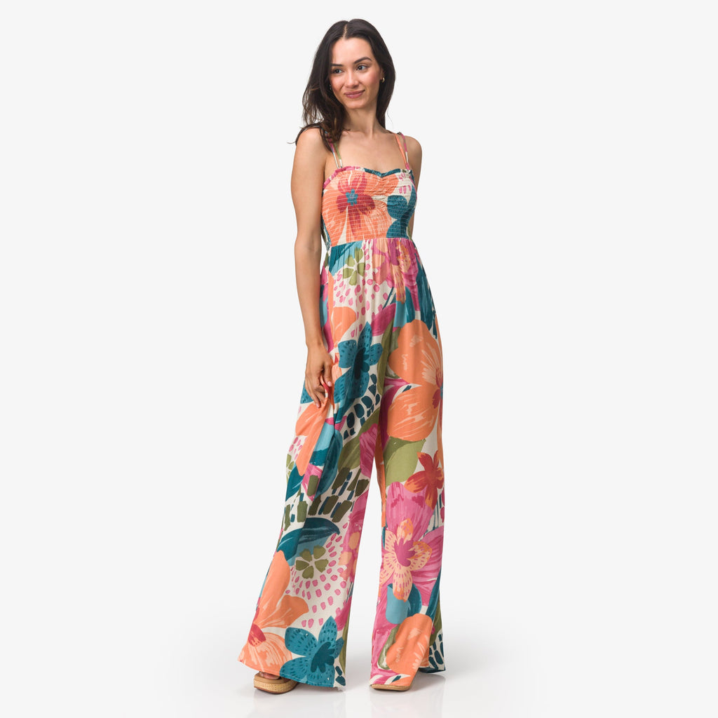 Woman wearing colorful floral Eve Wide Leg Romper standing with relaxed posture, full body view for beach lifestyle apparel.