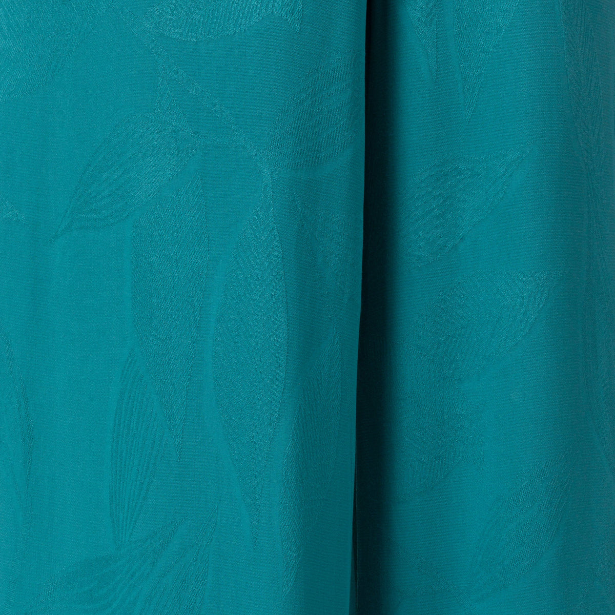 Ollie Tank close-up of teal fabric texture with subtle surf-inspired pattern, designed for comfort and beach lifestyle.