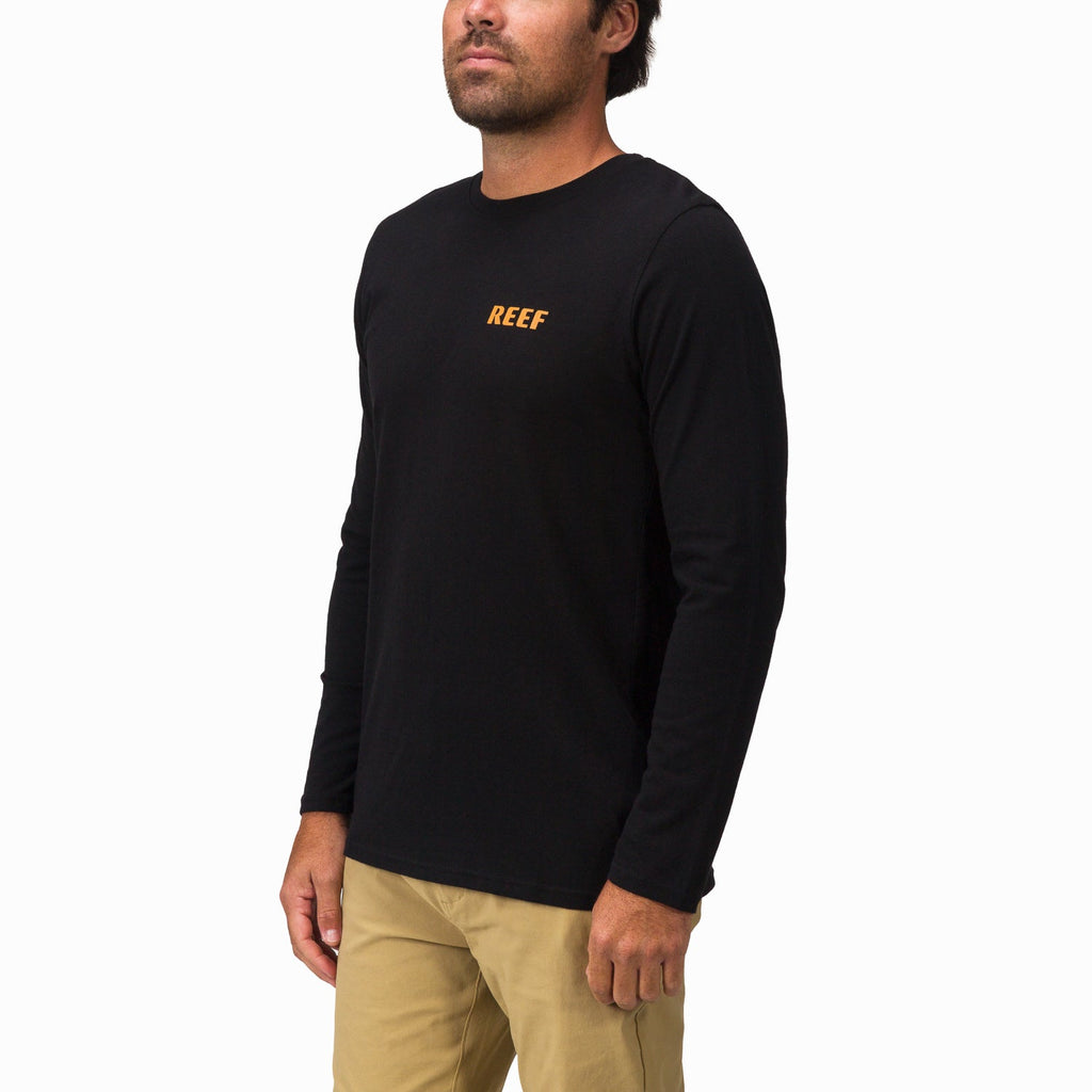 Man wearing black Wellie 24 Long Sleeve Tee facing front right, featuring reef logo on chest, beach-inspired apparel.