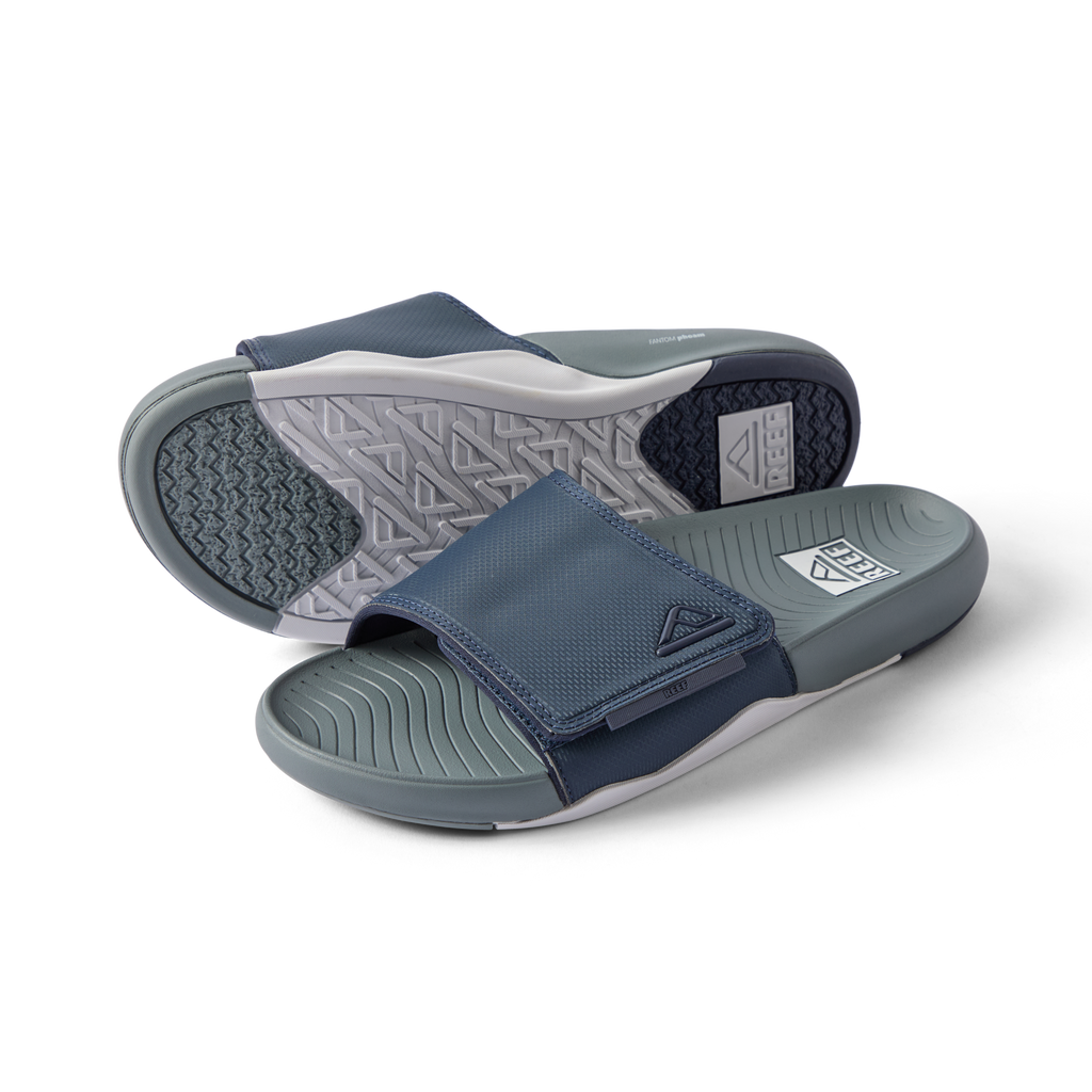 Phantom Slab men's slide sandals facing left with breathable navy grey straps and cushioned footbeds for beach comfort.