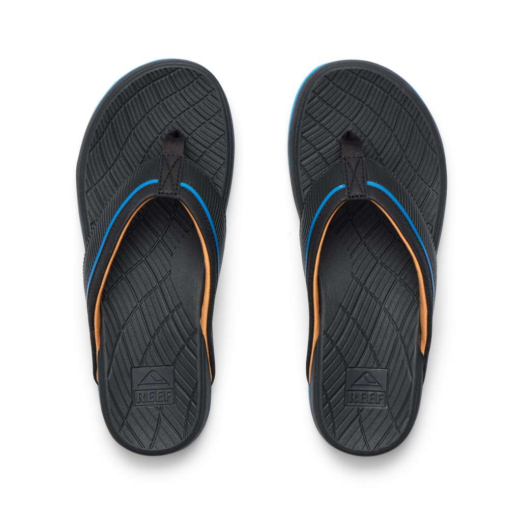 Kids Windswell black and blue flip flops for boys, top view showing textured footbed with arch support and soft cushioning.