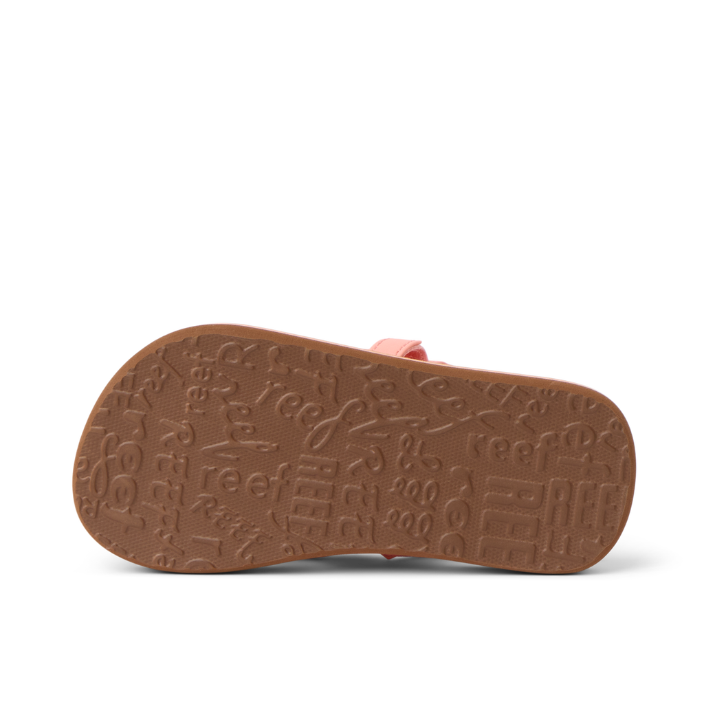 Little Ahi girls’ sandal sole facing up, showing textured outsole with Reef branding, comfort-focused and durable design.