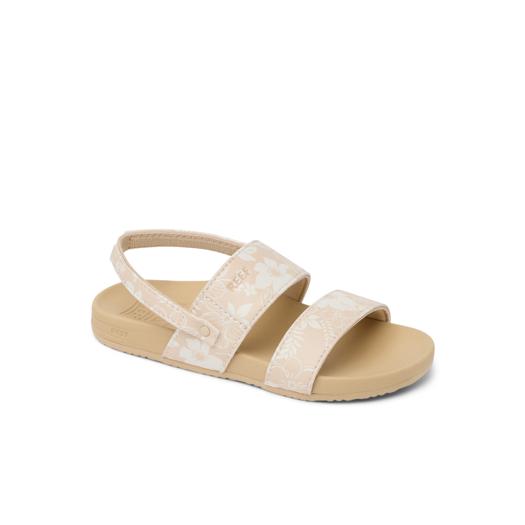 Little Cushion Vista girls sandal facing left, white floral straps, tan cushioned sole, surf-inspired comfort design.