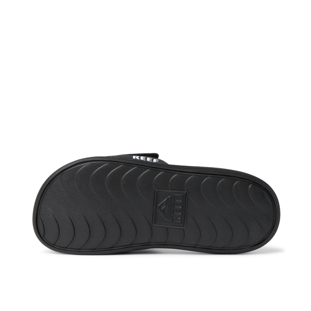 Little Salty Slide showing black outsole facing up, close-up of water-friendly durable sole with arch support for boys age 2-4.