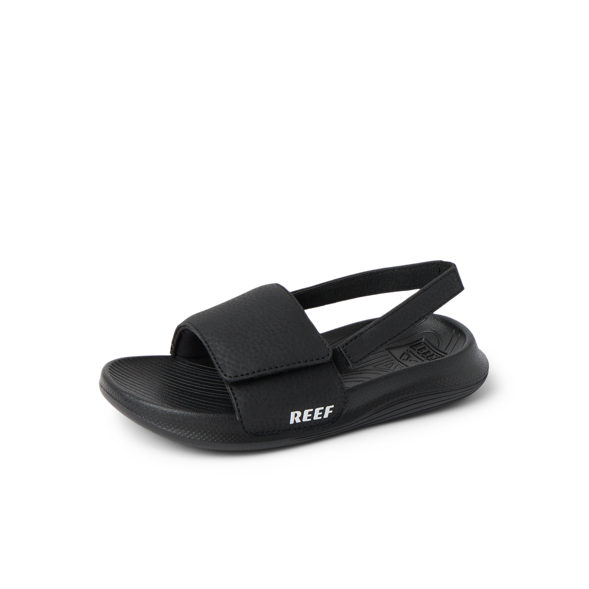 Little Salty Slide sandal for boys facing right, black with adjustable strap, featuring comfort cushioning and arch support.