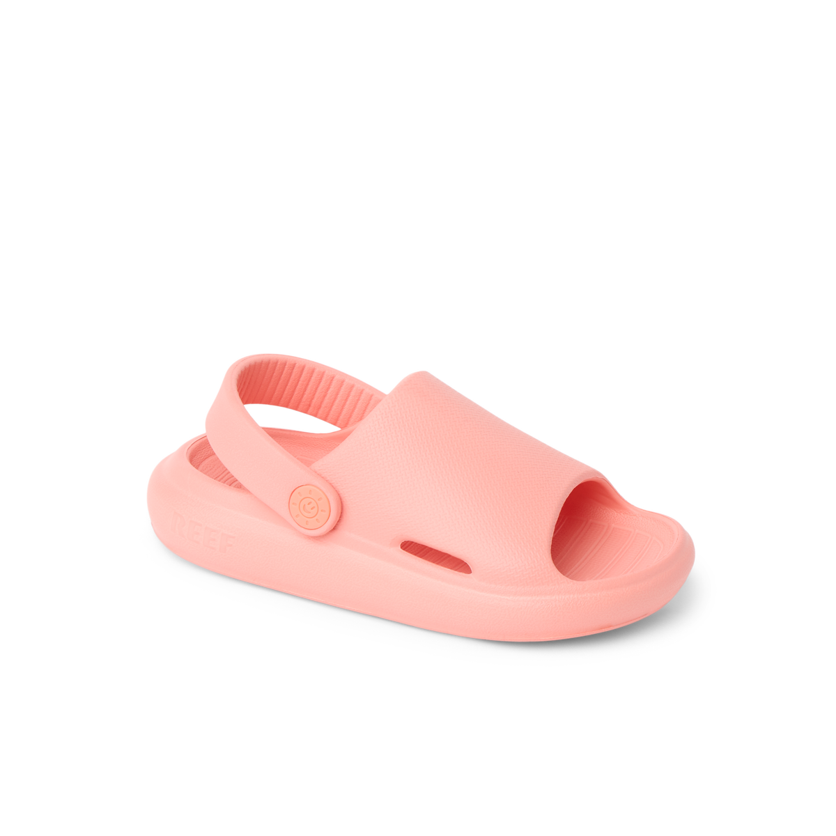 Little Rio Slide coral-colored kids’ slide sandal facing left, showing top and side with comfortable cushioned sole.