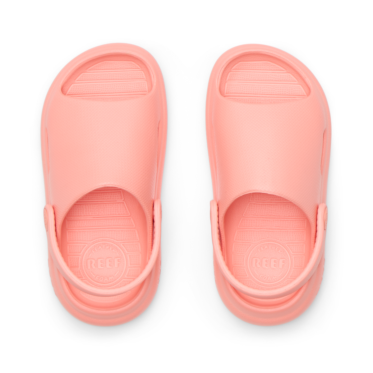 Top view of coral Little Rio Slide sandals for kids with molded footbeds and soft cushioning for beach comfort.