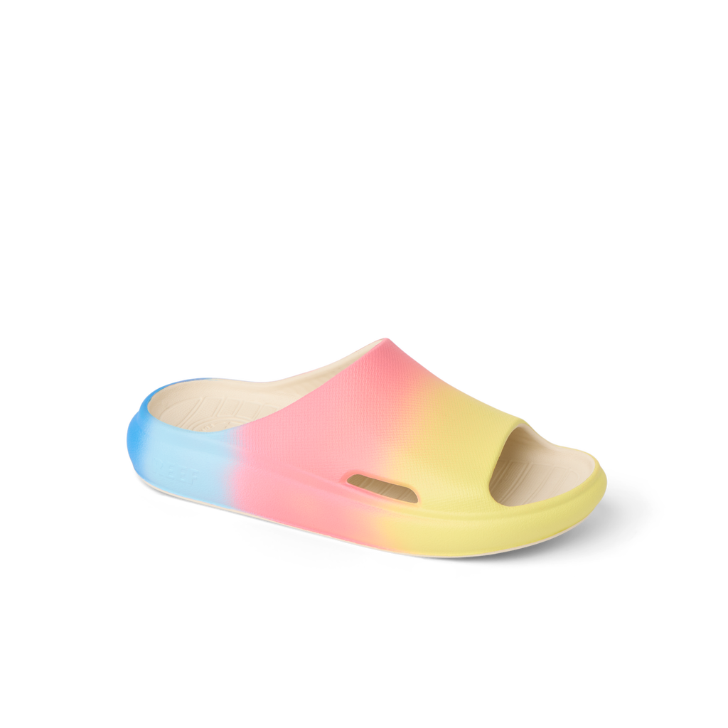 Kids Rio Slide facing right, close-up of the upper and partial sole in blue, pink, and yellow water-friendly materials.