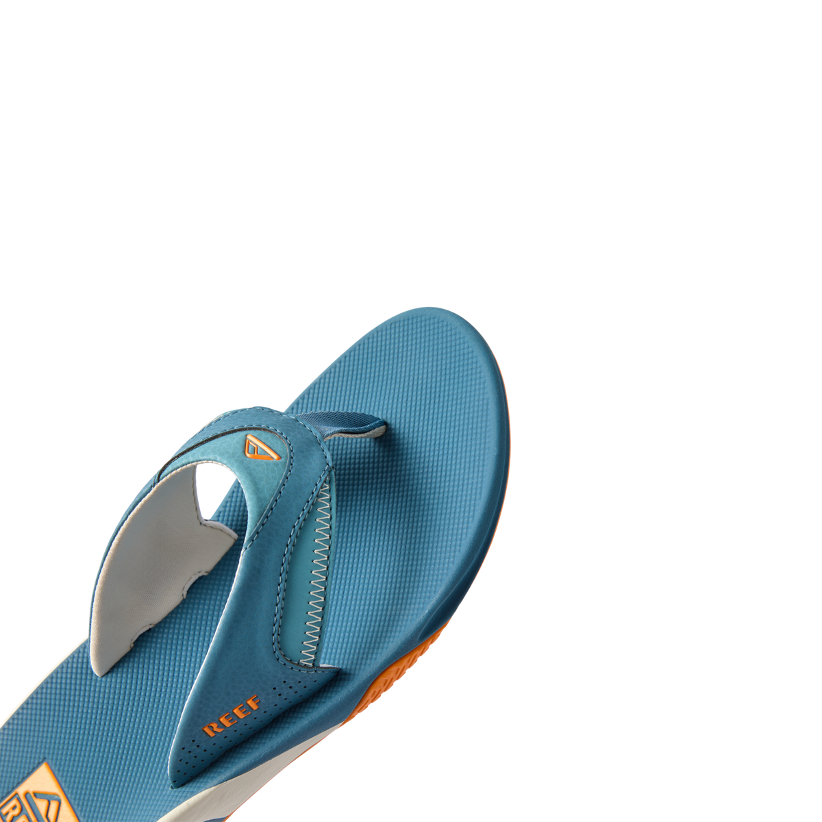 Fanning men's blue sandal facing left, close-up of top front footbed showing soft cushioning and arch support.