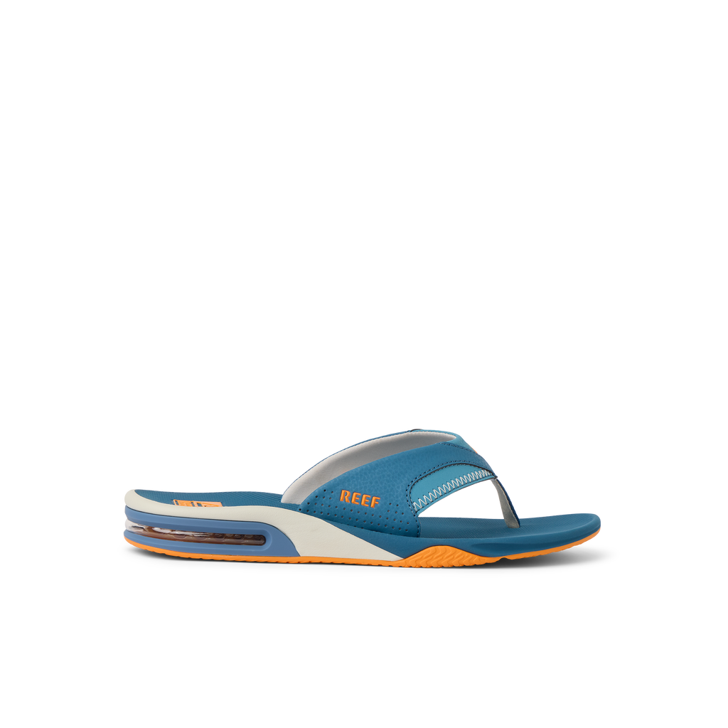 Fanning men's blue flip flop facing left, showing side with anatomical arch support and soft cushioning sole.
