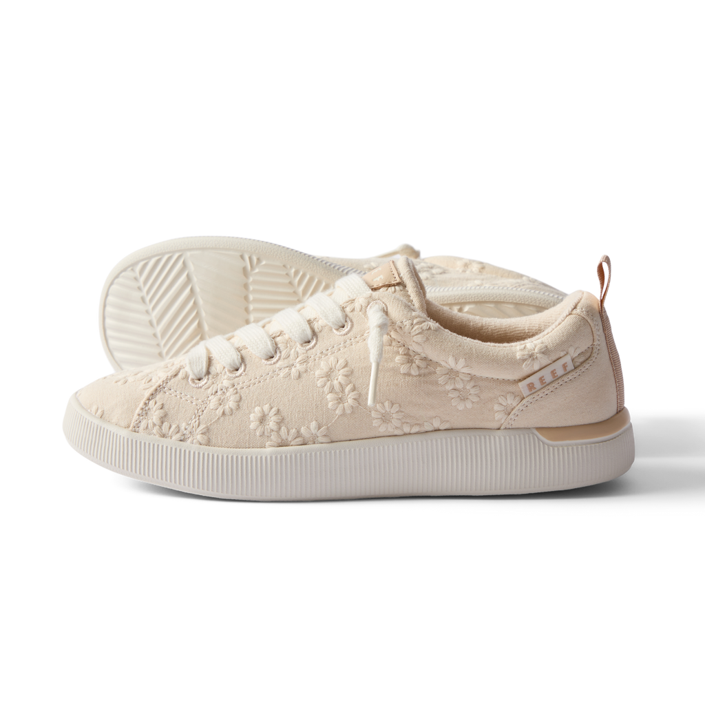 Side view of the left Neptune Alana sneaker for women with floral embroidery and enhanced arch support.