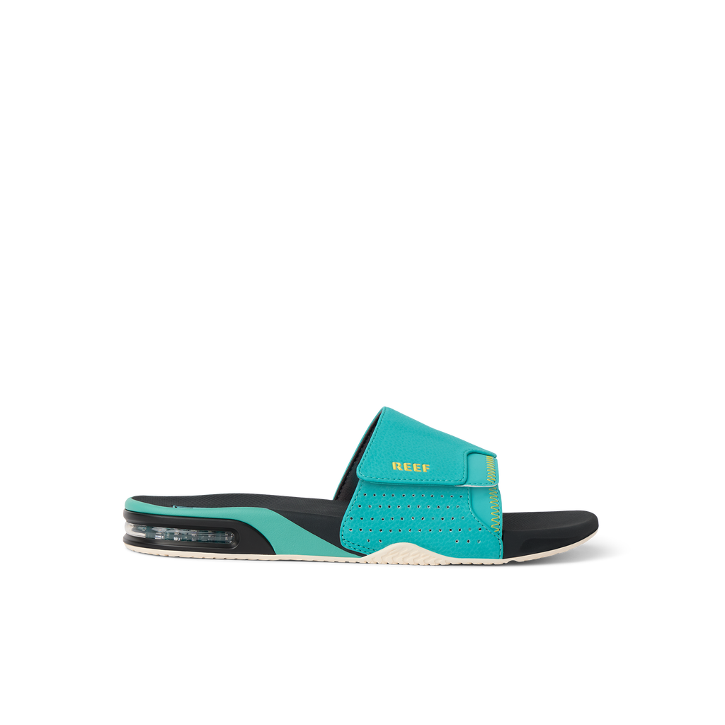 Fanning Slide sandal facing right with teal upper, black footbed, anatomical arch support, and cushioned sole for comfort.