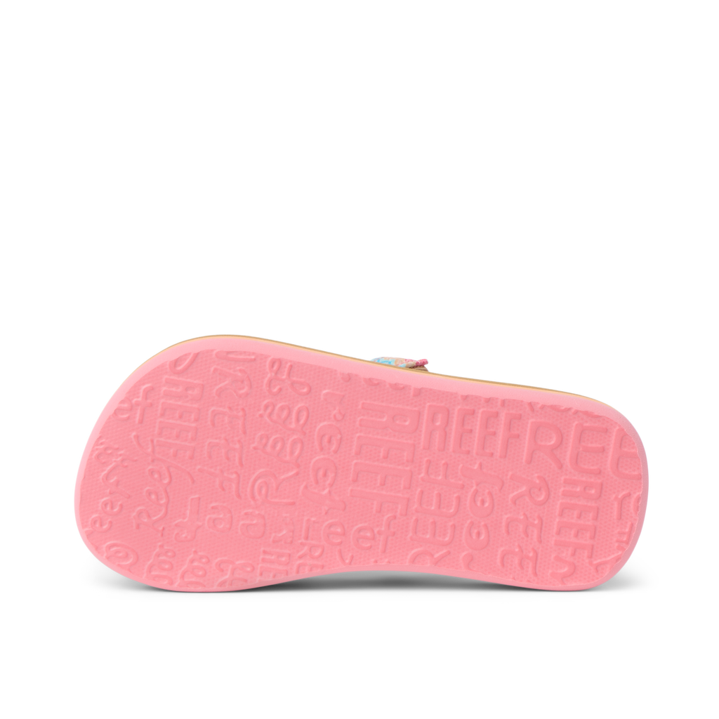 Little Ahi girls’ sandal showing bottom sole facing up with textured REEF branding in pink, lightweight comfort design.