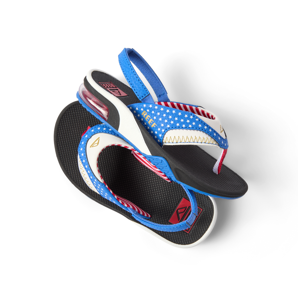 Little Fanning boys' sandals with patriotic blue strap facing right, showing cushioned footbed and heel strap close-up.