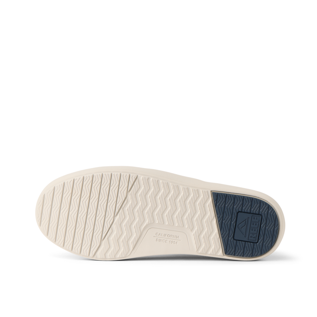 Neptune Lido men's shoe sole facing up, showing textured water-friendly outsole with navy heel patch and arch support.