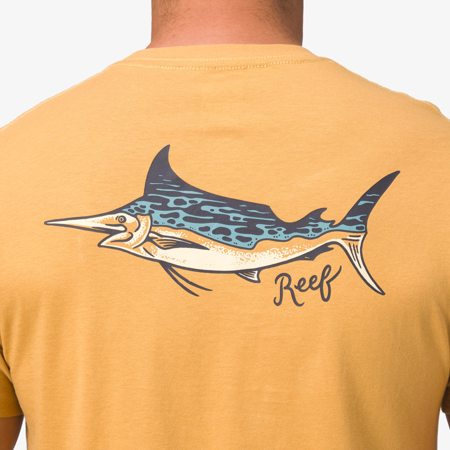 Back view of a man wearing a honey mustard Jacob Tee featuring a colorful marlin fish graphic and Reef branding.