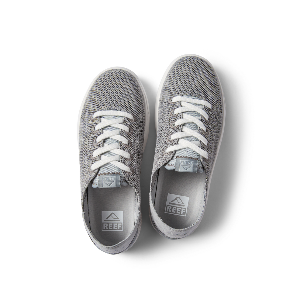 Top view of gray Kids Neptune sneakers with white laces, knit upper, and Reef logo insoles, designed for comfort and the beach.