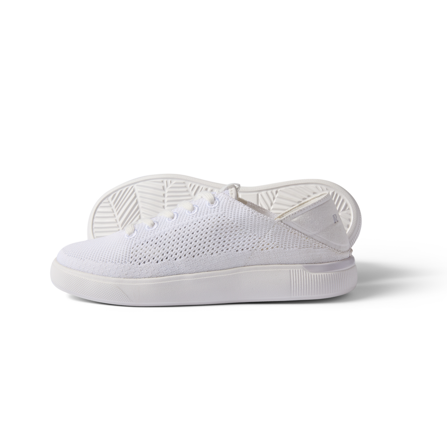 Kids Neptune white sneaker facing left, close-up of side with breathable knit upper and cushioned sole.