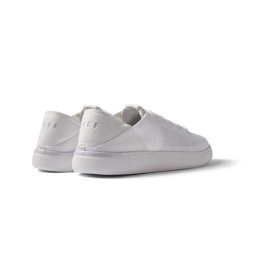 Kids Neptune white breathable sneakers facing backward showing heel with anatomical arch support and cushioning