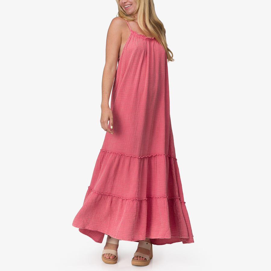 Woman wearing pink Lainey Maxi Dress with tiered skirt and sandals facing forward, highlighting beach-inspired comfort style.