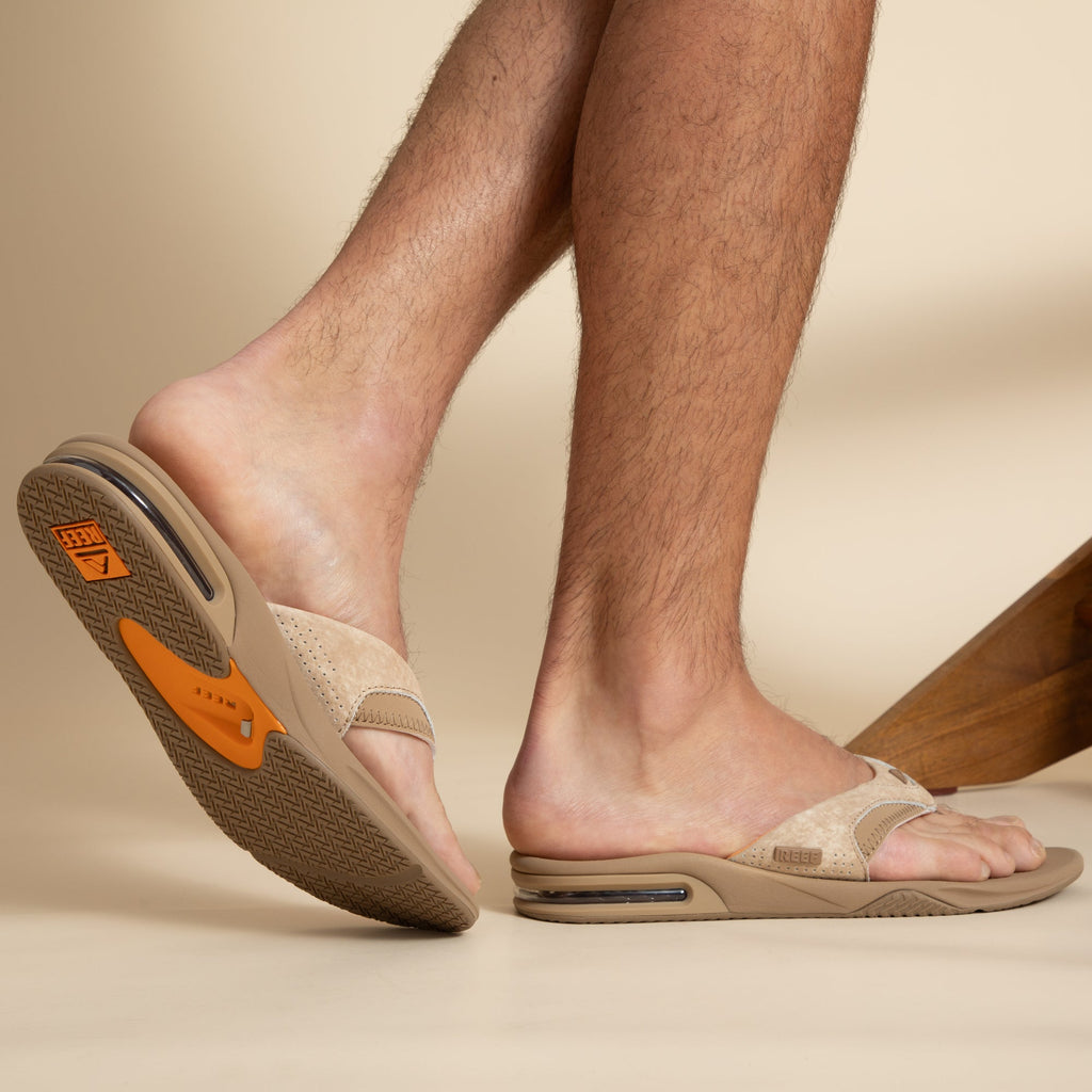Fanning men's tan sandal facing right, showing sole and side with soft-rebound cushioning and arch support.