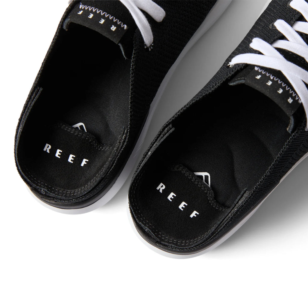 Close-up top view of the black Neptune HT shoes facing upward, showcasing REEF comfort and arch support.