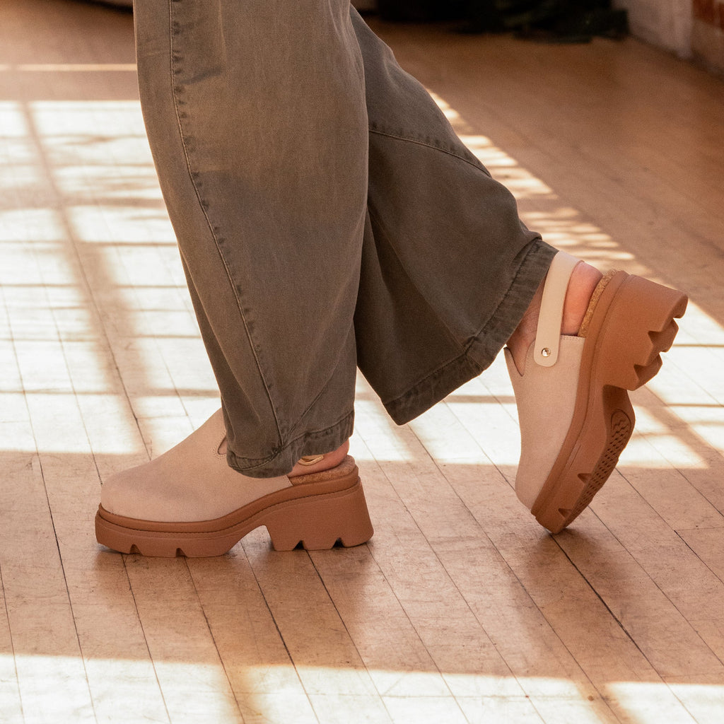 Vista Luxe Solene platform clogs facing left and right, showing side and sole views with adjustable straps and arch support.