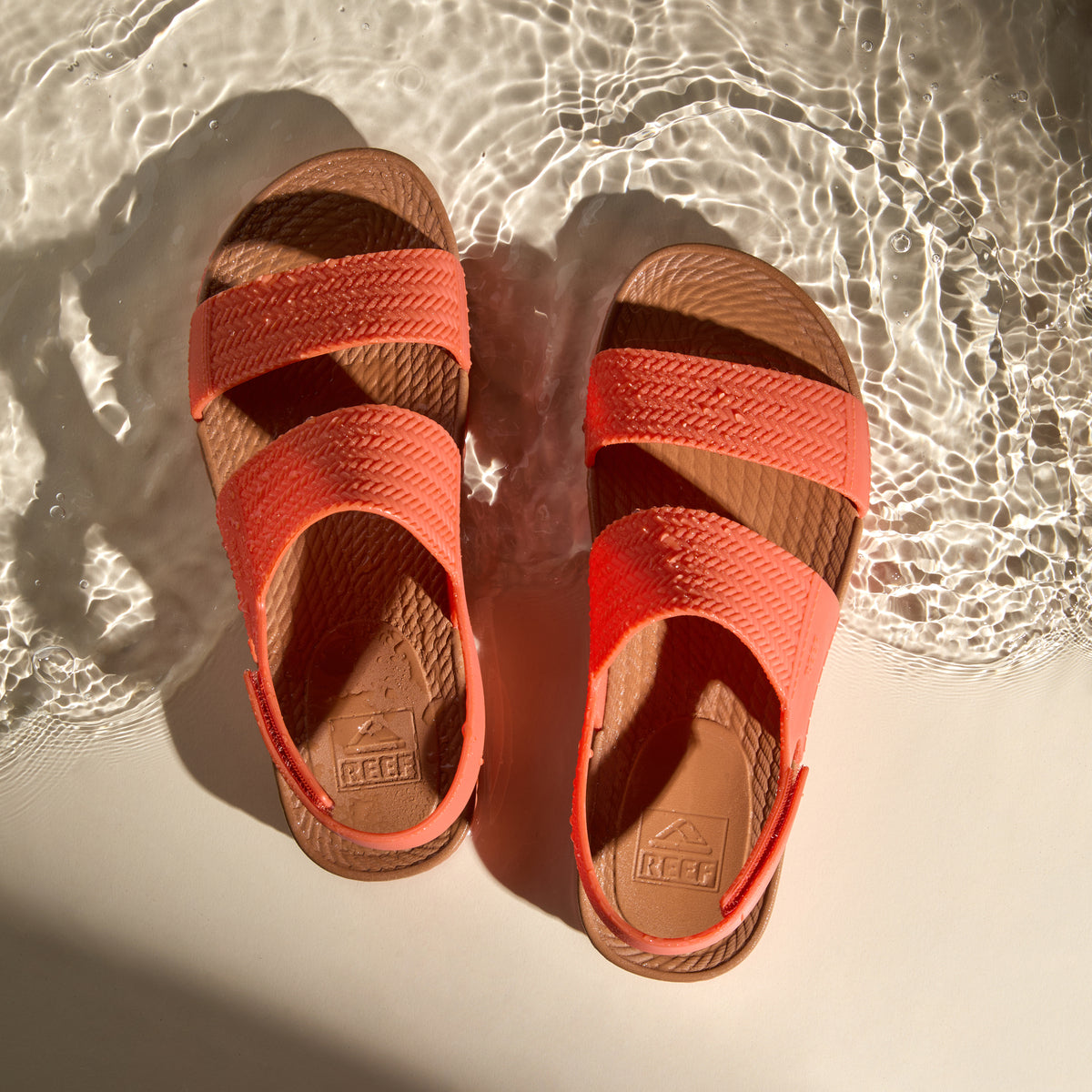 Top view of Reef Water Vista women's sandals in orange rust with anatomical arch support and water-friendly design.